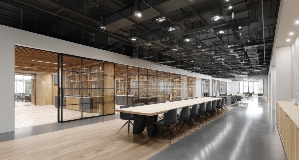 Modern open-plan office space with large conference table and glass-walled rooms